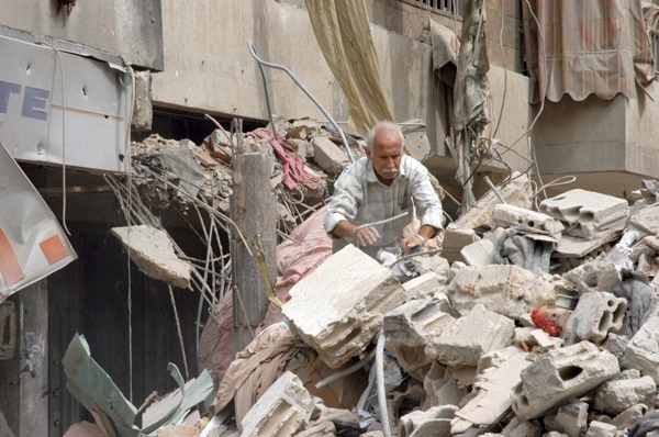 17 August 2006, Lebanon, Beirut, Dahia. 2006 Lebanon War. Unidentified old man, goes through rumbbles to find anything that can be used. 