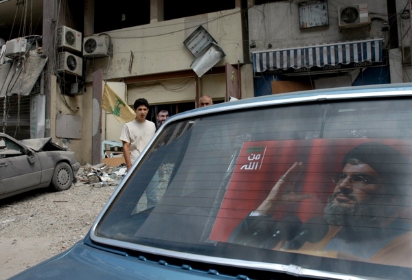17 August 2006, Lebanon, Beirut, Dahia. 2006 Lebanon War. Unidentified men, standing by a car were the photo of Sheikh Sayyed Hassan Nasrallah , leader of the Lebanese Hezbollah.