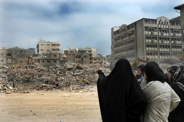 17 August 2006, Lebanon, Beirut, Dahia. 2006 Lebanon War. Unidentified women, having scarfs in their faces to avoind dust and smell, standing by and looking at the destroyed buildings. 