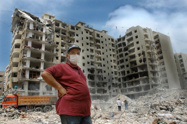 17 August 2006, Lebanon, Beirut, Dahia. 2006 Lebanon War. Unidentified man wearing a mask to avoid the smell and dust at the bombed area