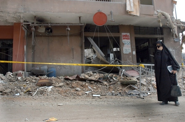17 August 2006, Lebanon, Beirut, Dahia. 2006 Lebanon War. Unidentified woman, walks by breakage. 