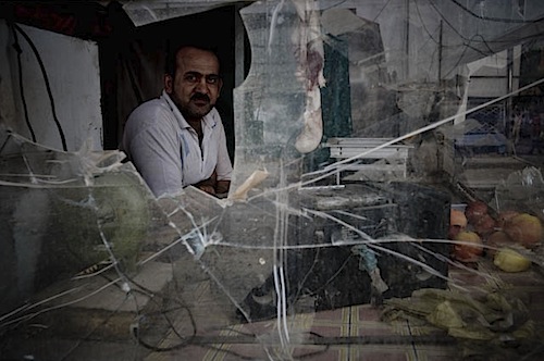 zoriah_iraq_war_baghdad_sadr_city_wall_merchant_shop_damage.jpg